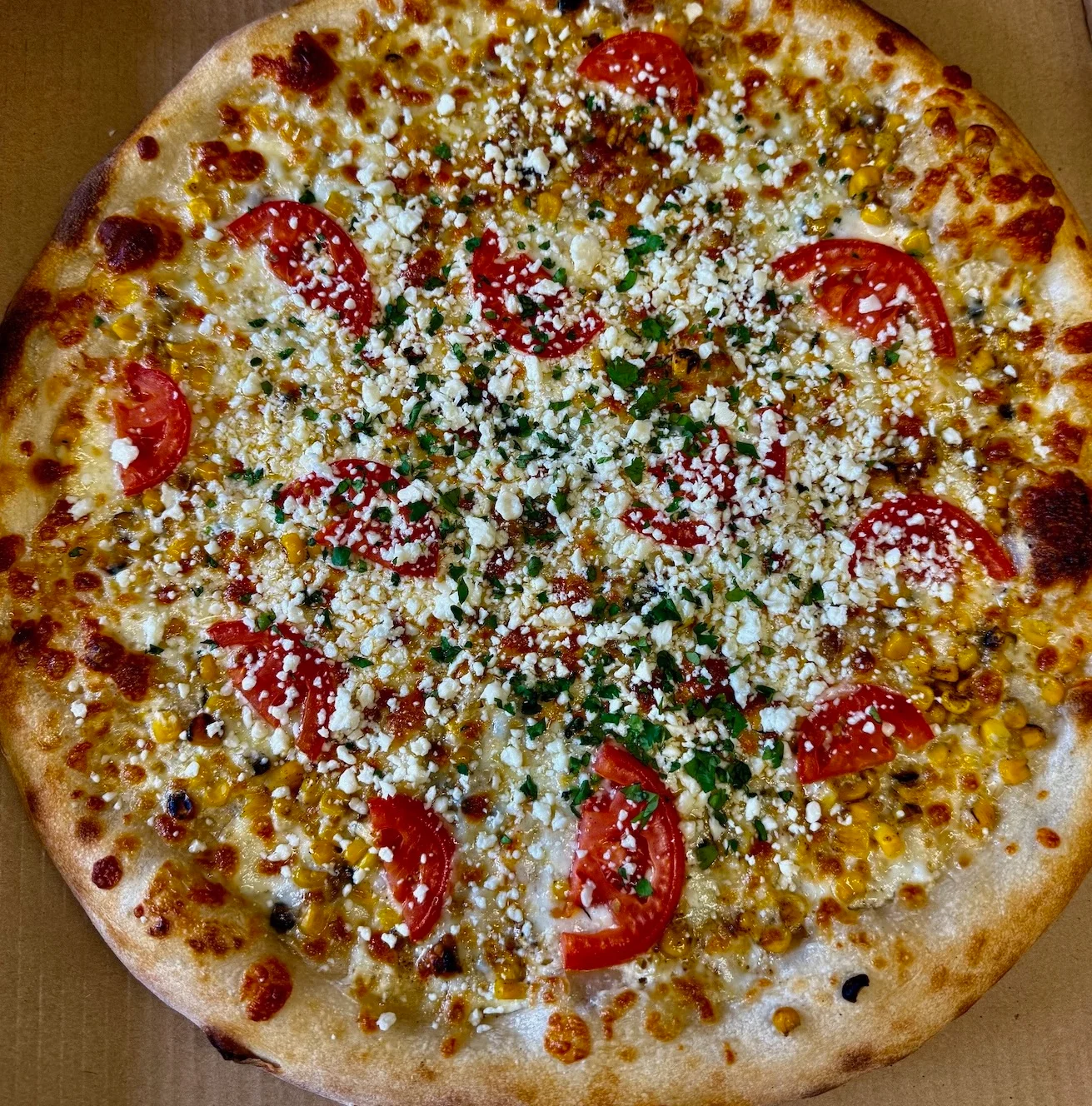 A close-up of a pizza slice featuring melted cheese and a golden crust.