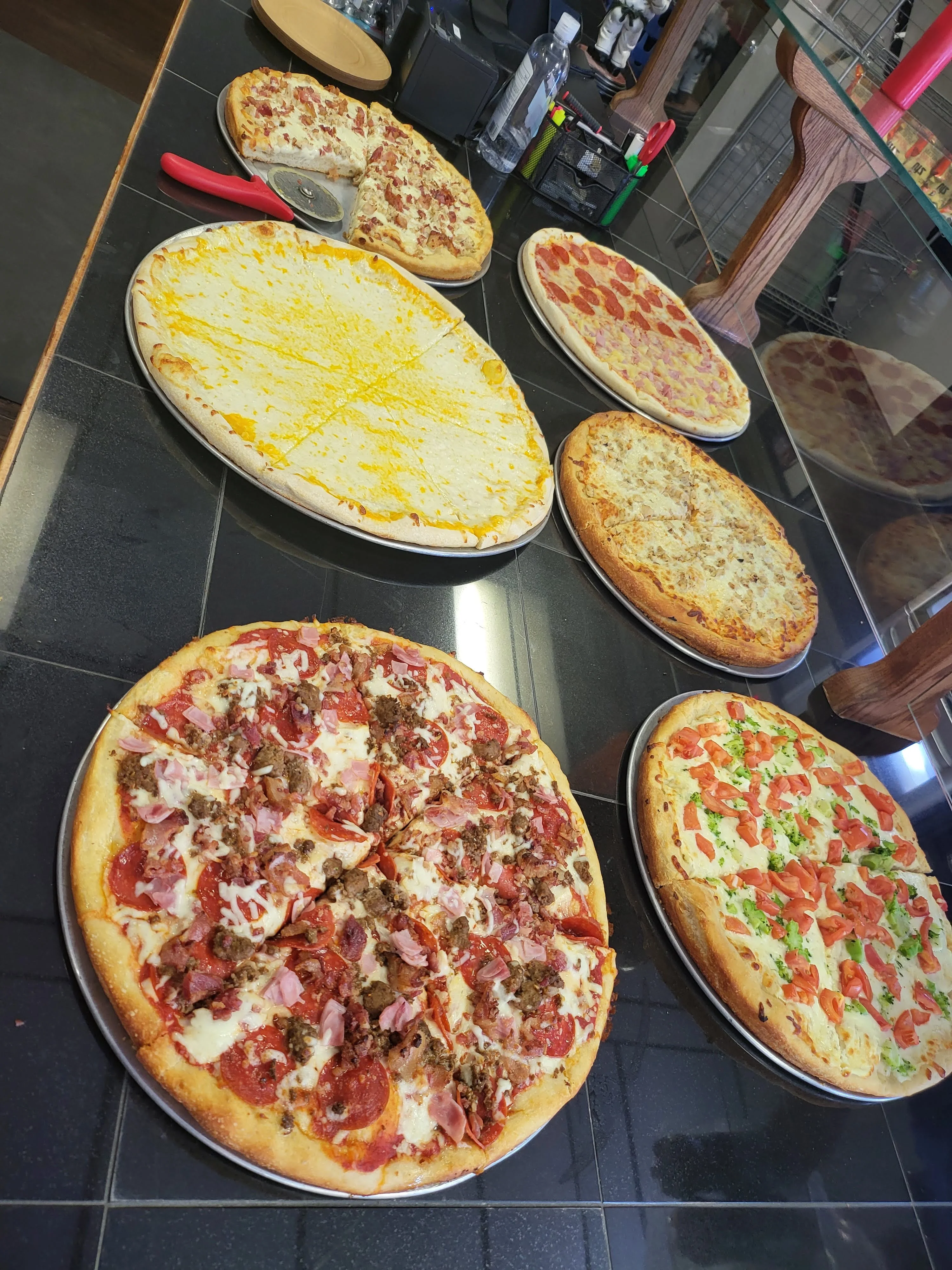 Variety of pizzas including pepperoni and cheese