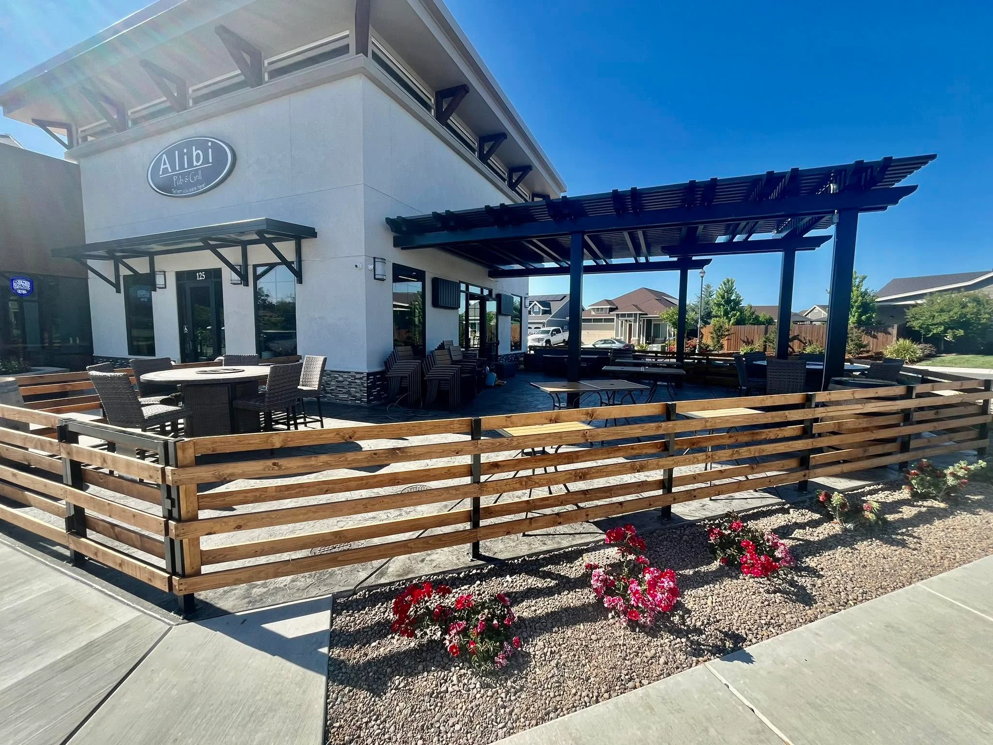 Outdoor dining area of Alibi restaurant with patio seating