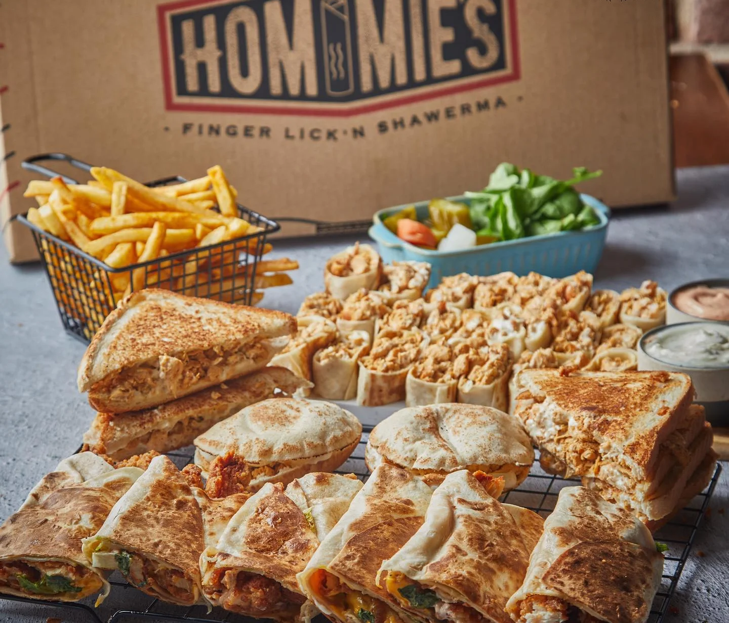 Assorted shawarma wraps and fries from a Middle Eastern restaurant