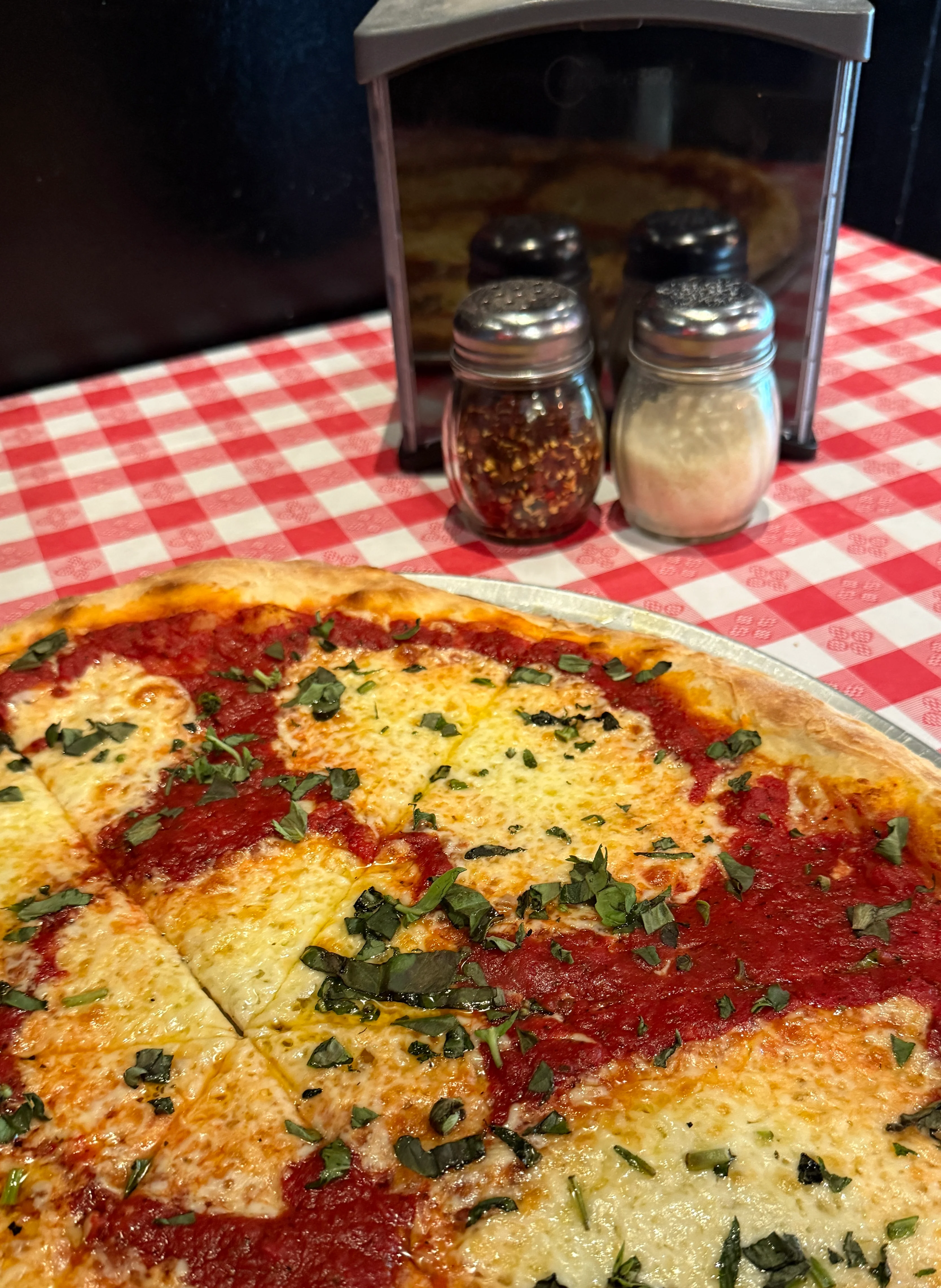 Classic Margherita pizza with fresh basil and tomato sauce