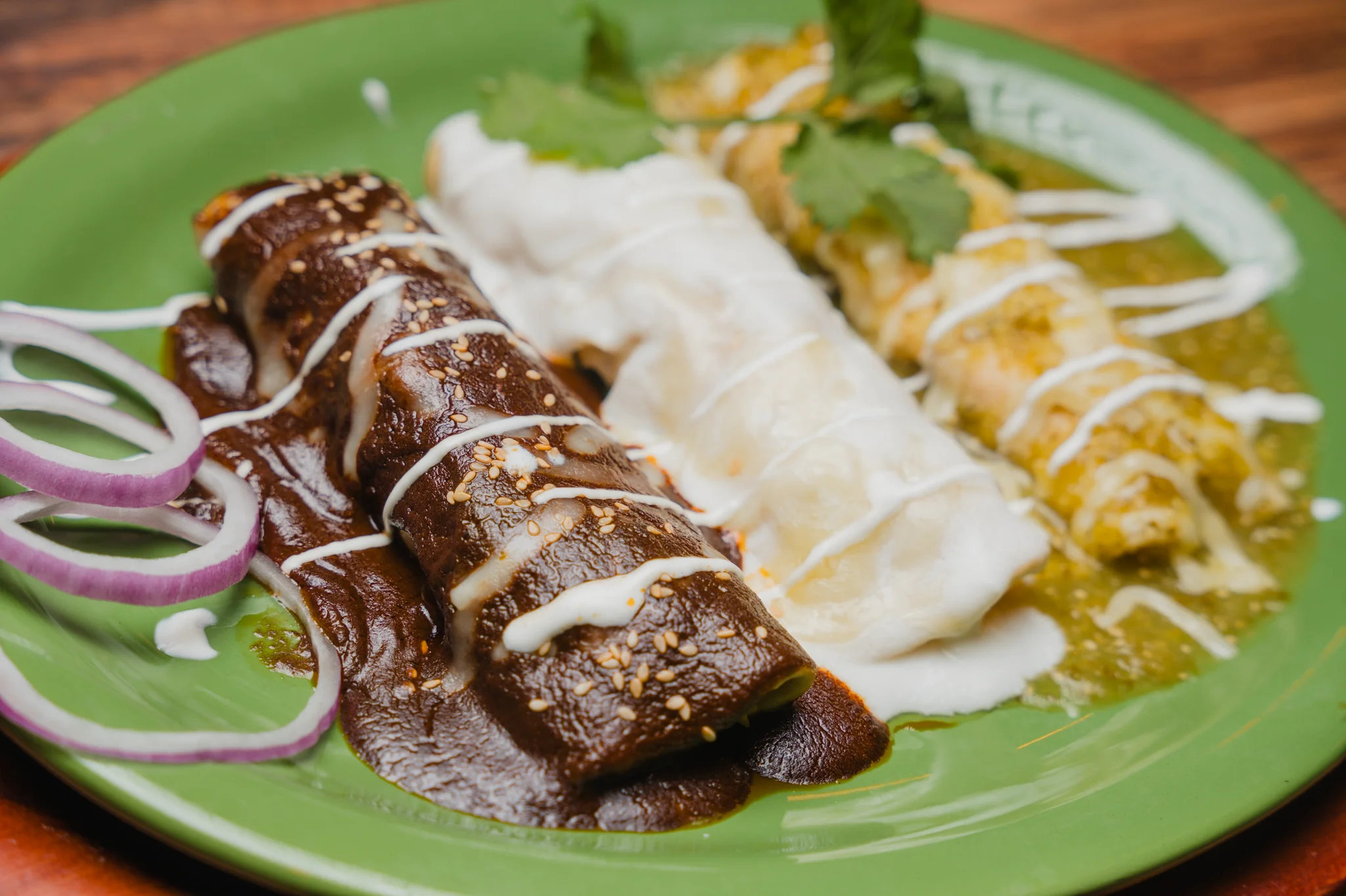 Colorful plate of Mexican enchiladas with various sauces