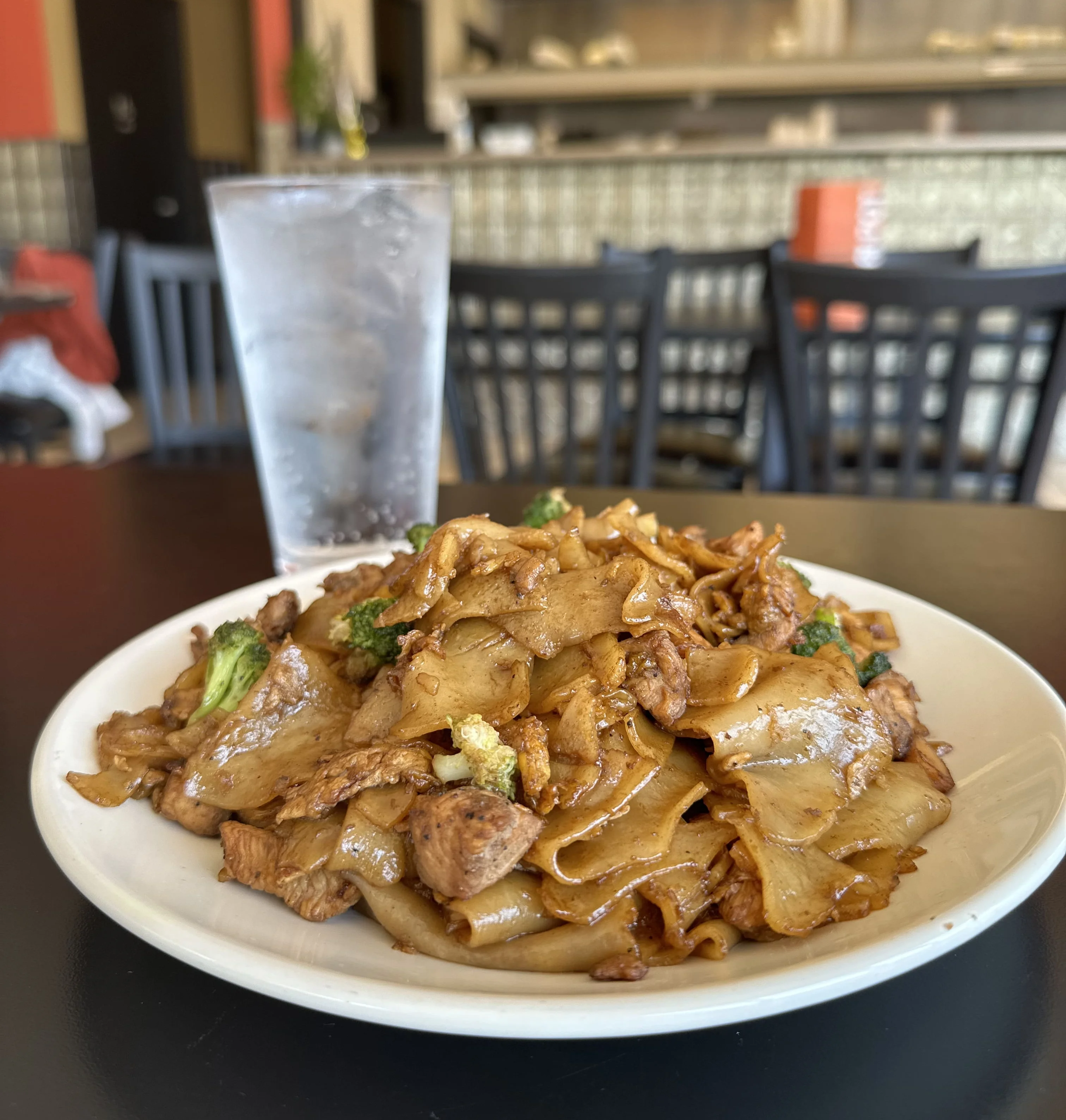 Plate of Thai pad see ew with chicken and broccoli
