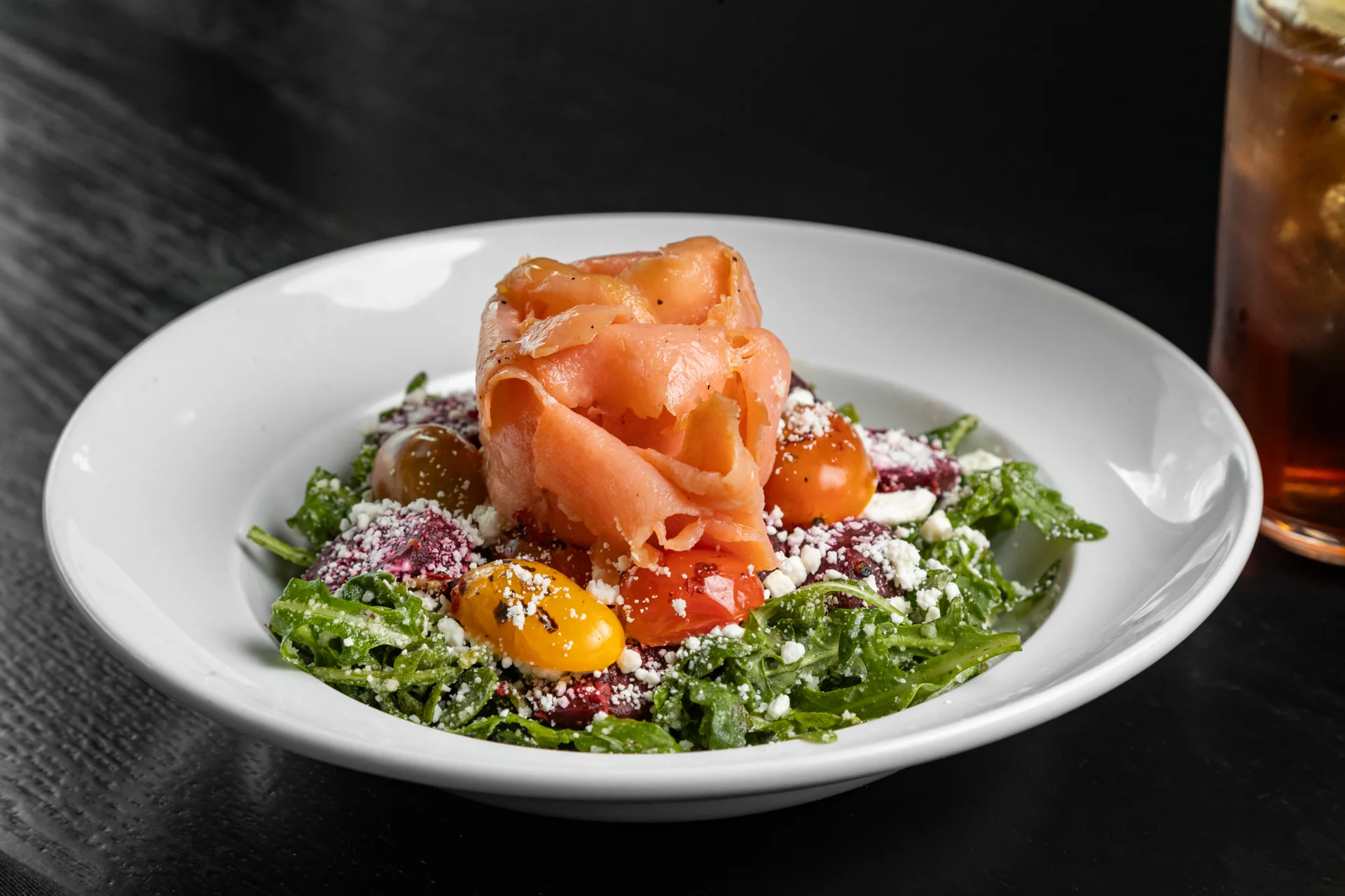 Arugula salad topped with smoked salmon