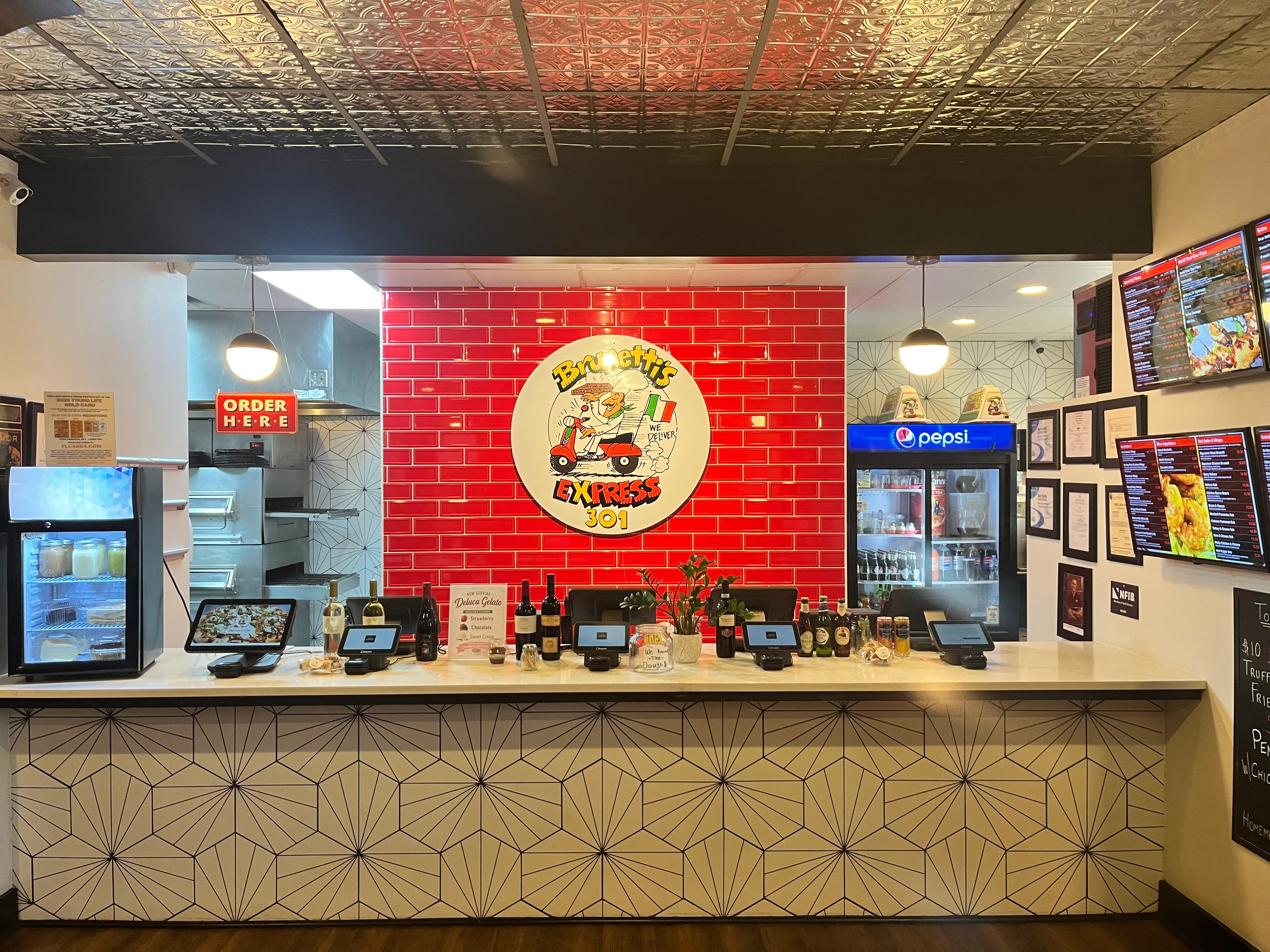 Modern restaurant counter with vibrant decor and digital ordering systems
