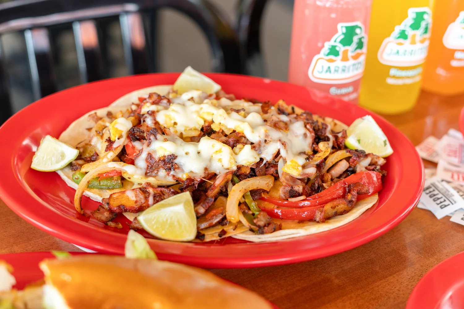Delicious Mexican tacos al pastor topped with cheese and lime