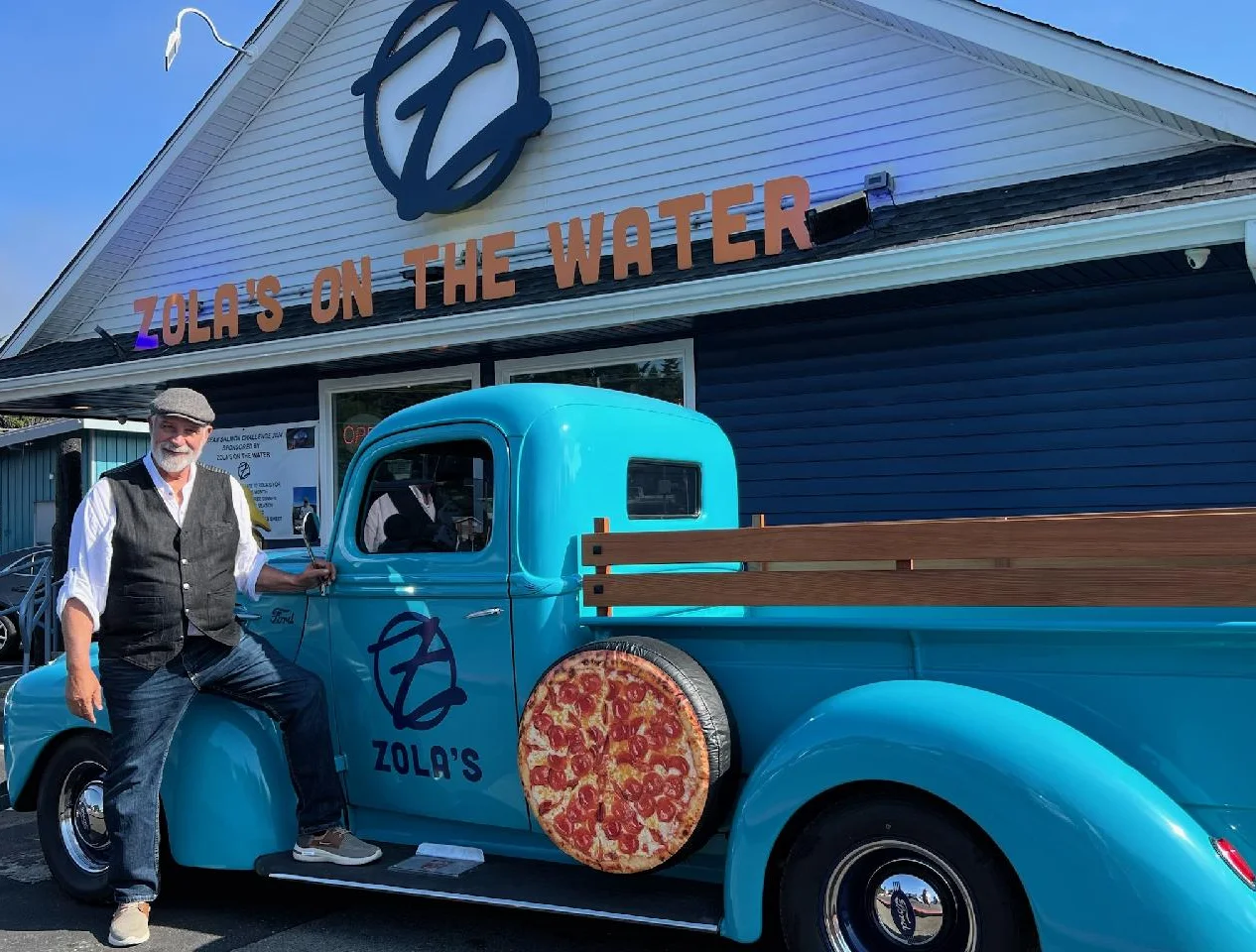 Zola's on the Water restaurant with vintage pizza truck