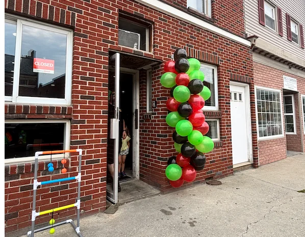 Colorful balloon arch at restaurant entrance