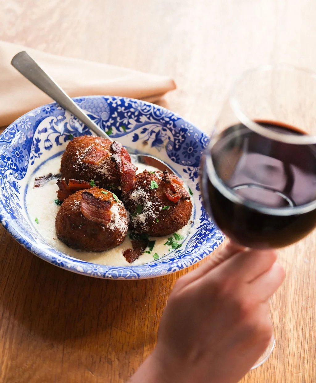 Southern hushpuppies served in a blue bowl with creamy sauce