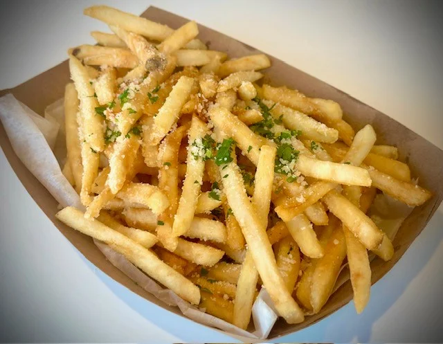 Crispy French fries topped with cheese and herbs