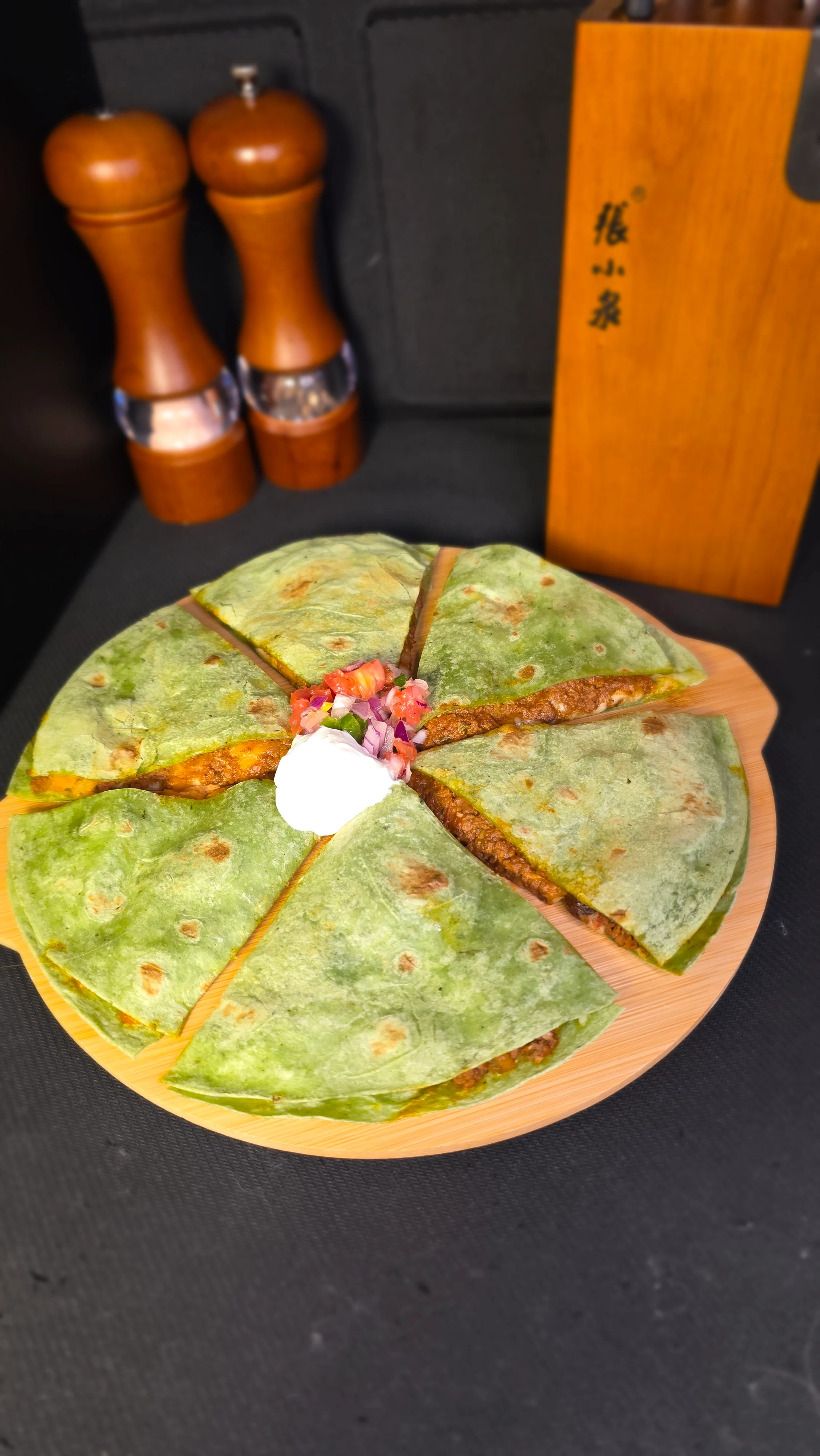 Mexican quesadilla with spinach tortillas and toppings