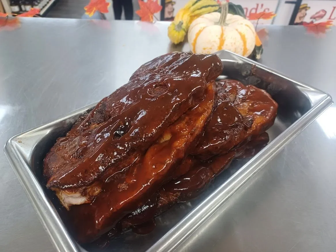 BBQ ribs glazed with rich sauce in a metal tray
