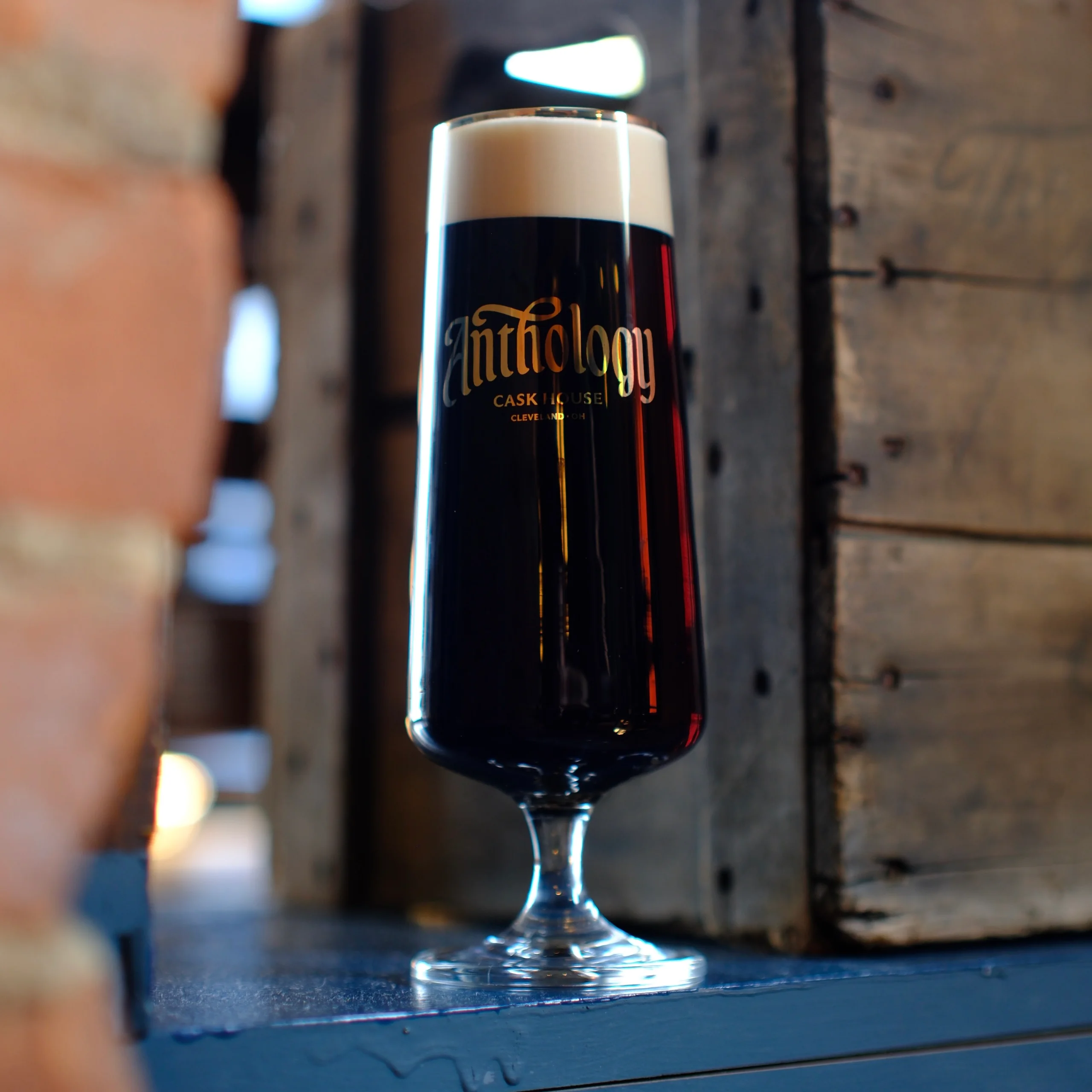 Craft beer served in a tall glass with creamy foam