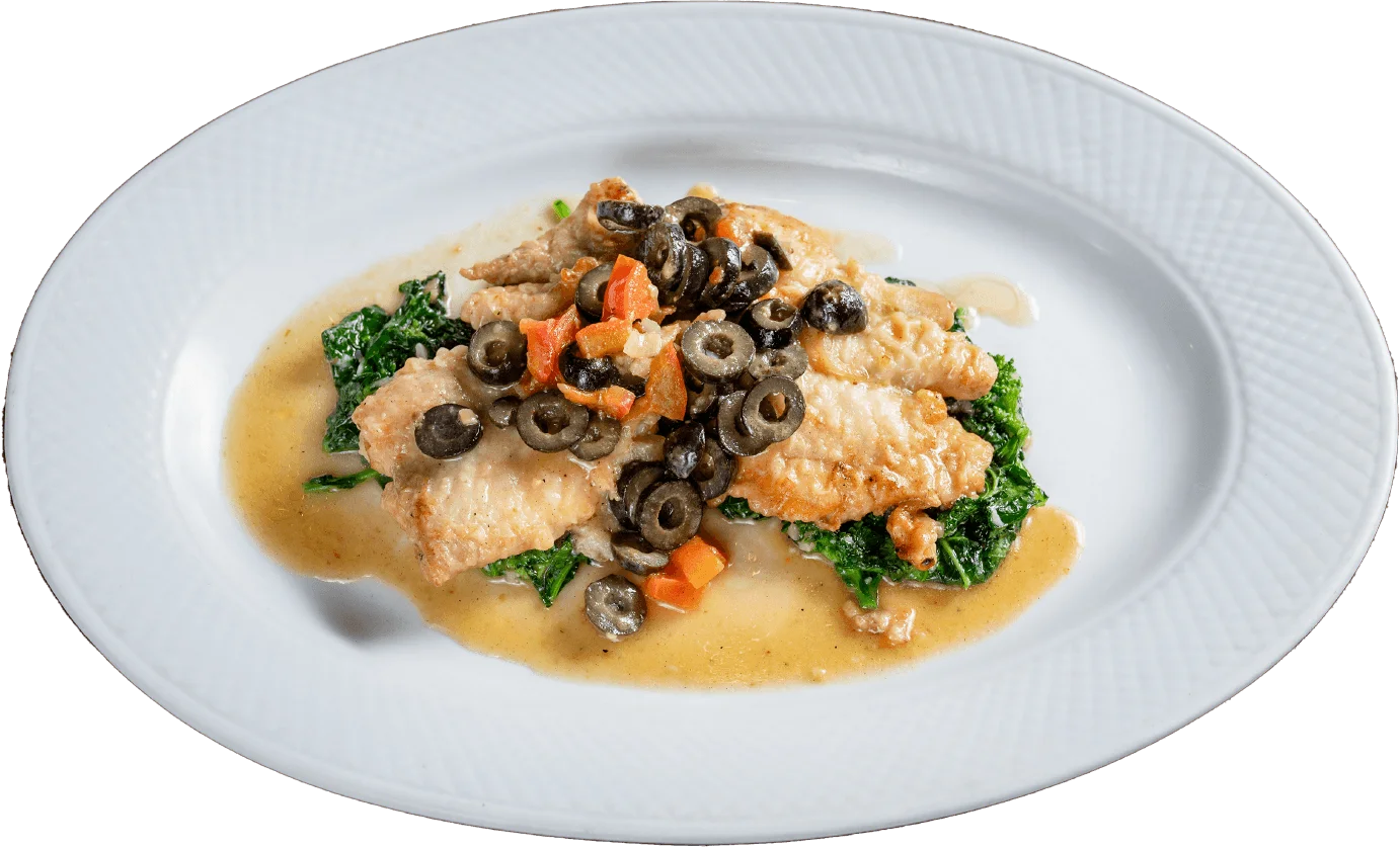 Pan-seared fish with olives on sautéed greens