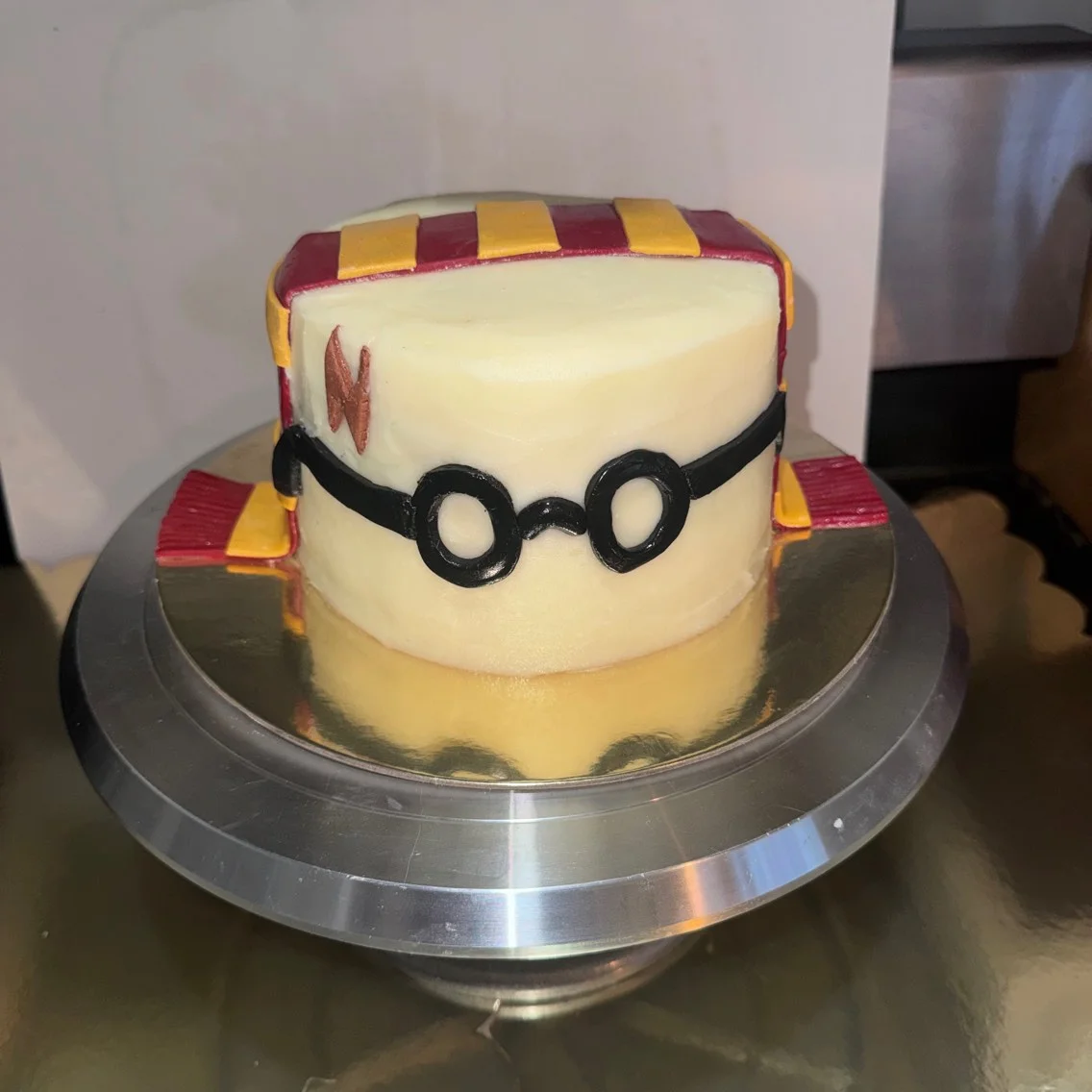 Creative Harry Potter-themed cake with glasses and scarf design