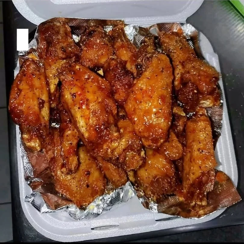 A box of deliciously glazed chicken wings, ready to be enjoyed.