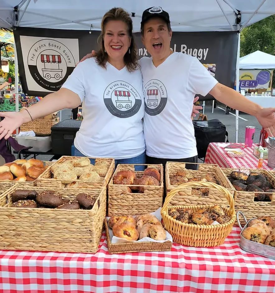Vibrant bagel stand at a market with smiling vendors