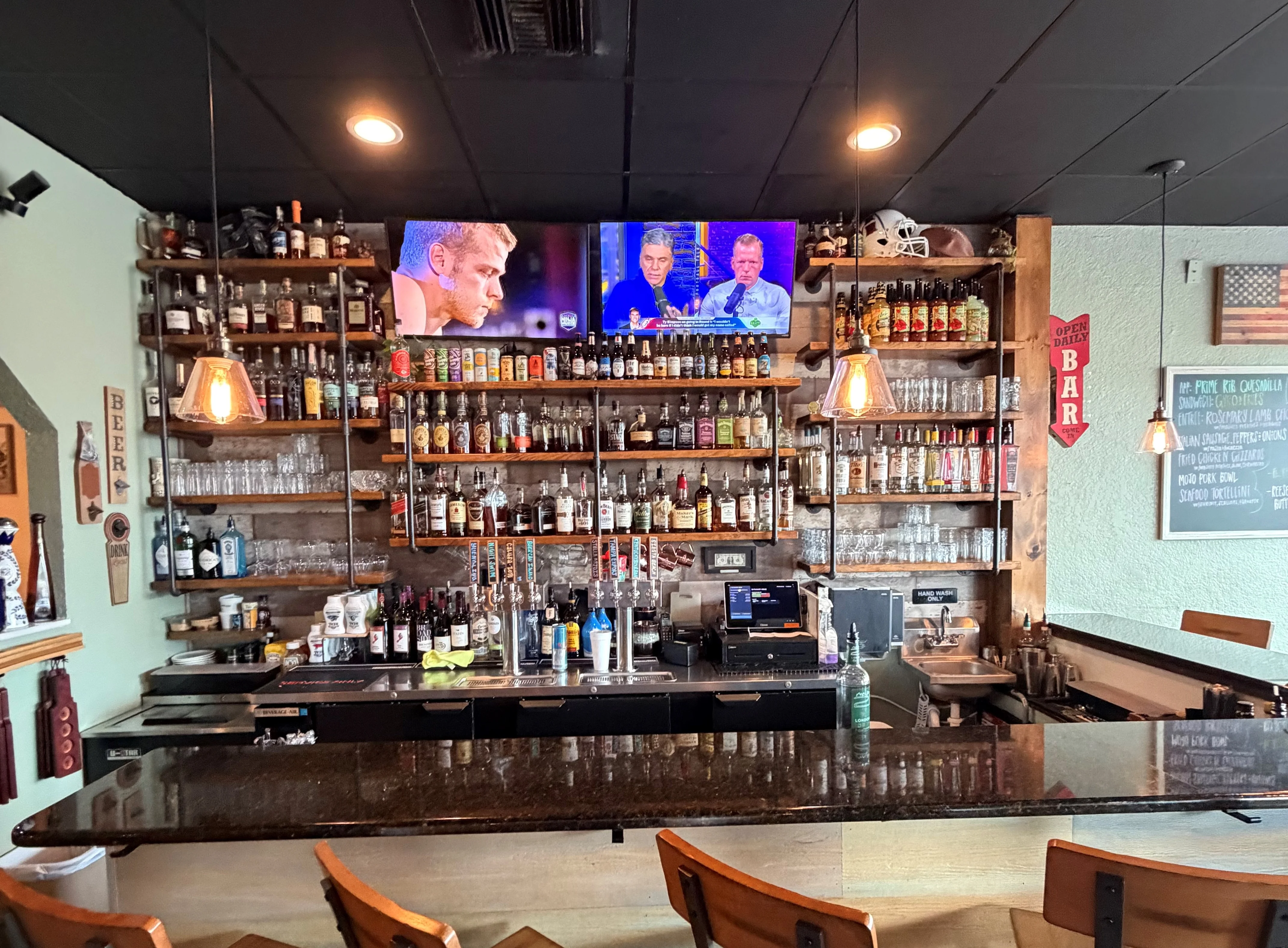 A vibrant bar backdrop featuring colorful bottles and a stylish design.