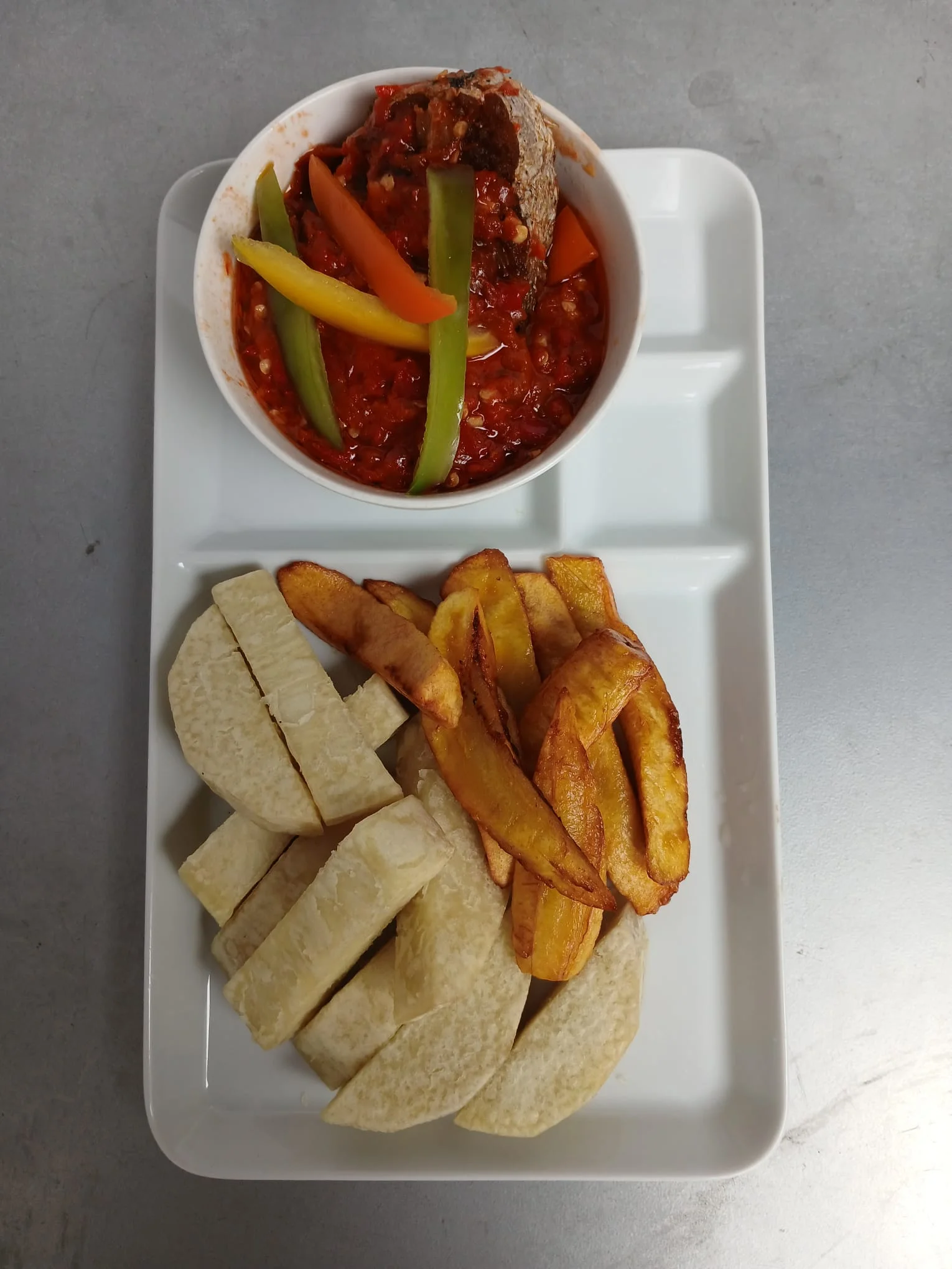 Nigerian jollof rice with plantains and pepper sauce