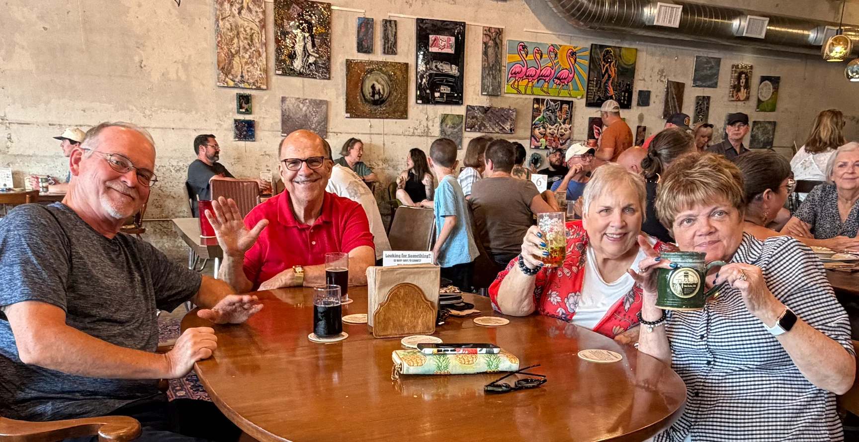 Friends enjoying drinks together in a lively restaurant dining room