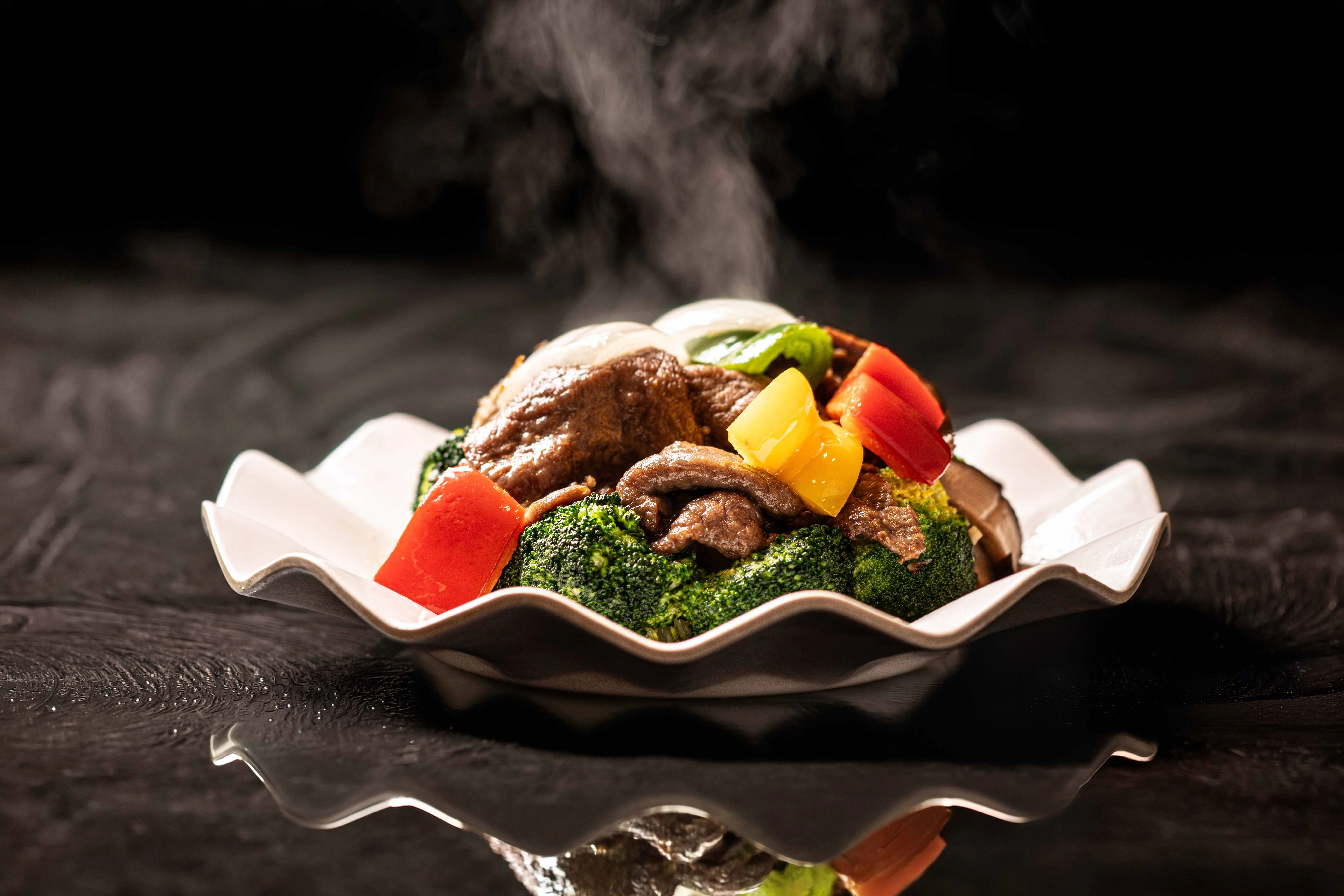 Sizzling beef and broccoli stir-fry in a decorative dish