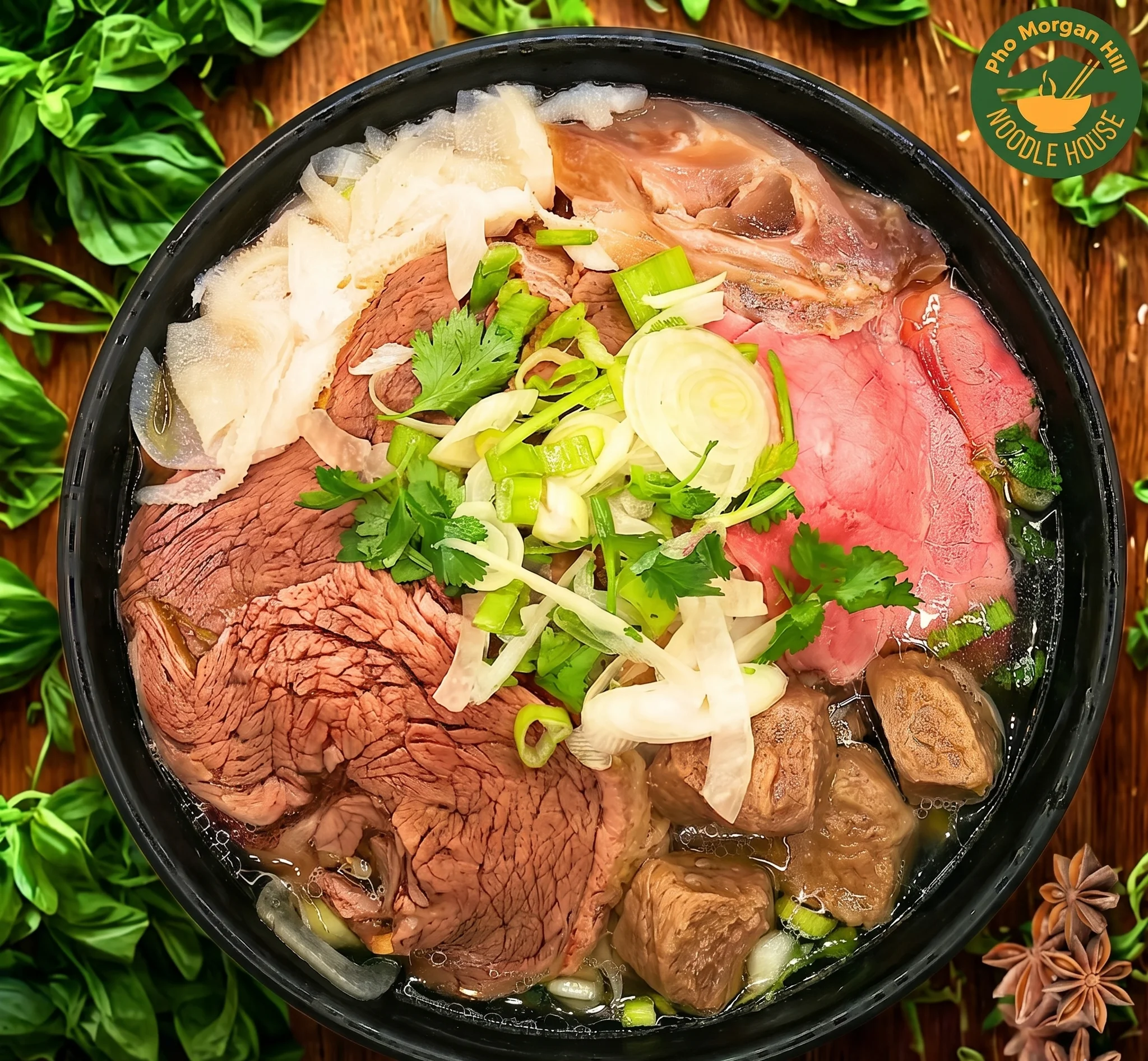 Bowl of Vietnamese pho with assorted beef cuts and fresh herbs
