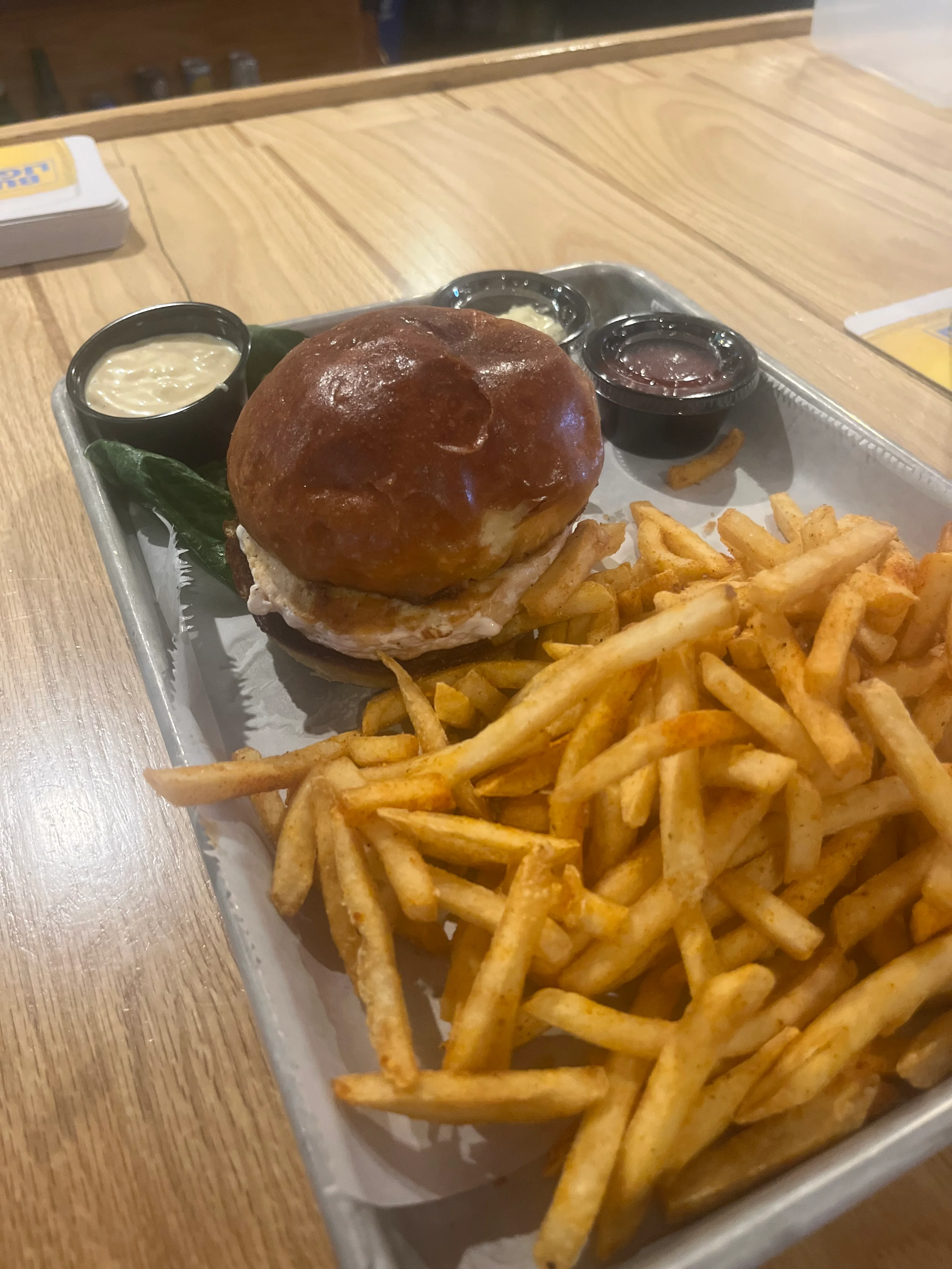 Crispy chicken sandwich with fries and dipping sauces