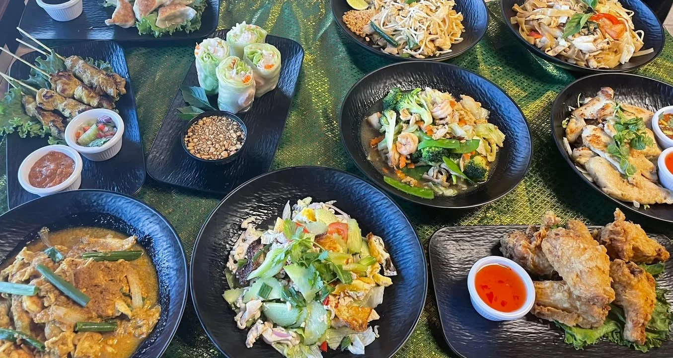 Assorted Thai dishes including spring rolls and pad thai
