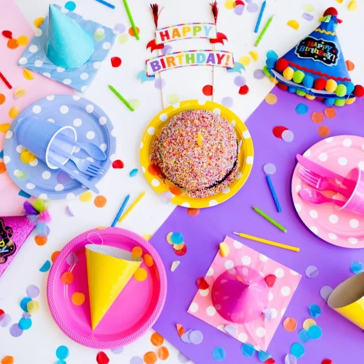 Colorful birthday party setup with cake and decorations