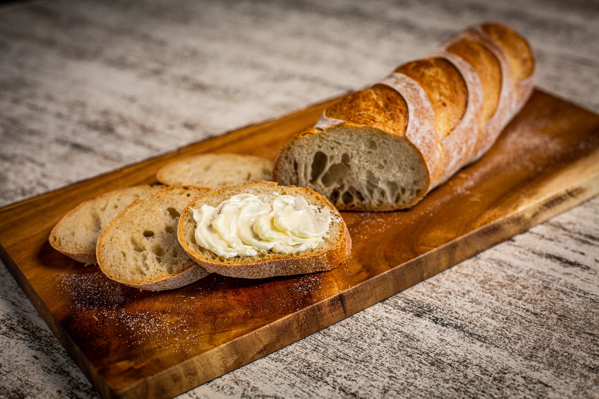 Freshly baked French baguette with creamy butter