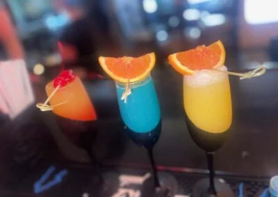 Colorful cocktails with fruit garnishes at a vibrant bar