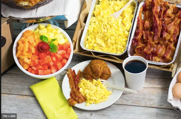 Classic American breakfast spread with eggs, bacon, and pastries