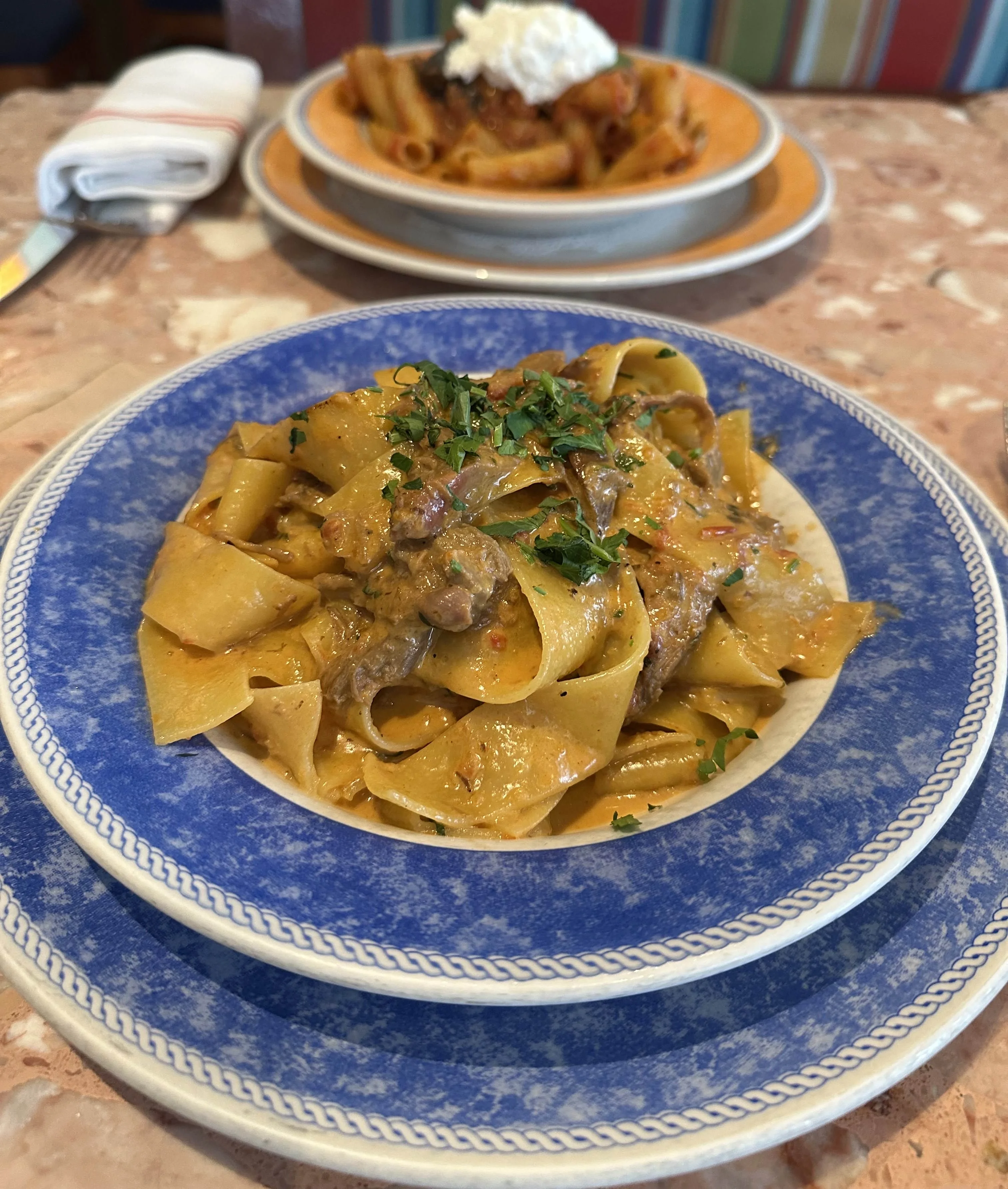 Plate of Italian pappardelle with rich meat sauce