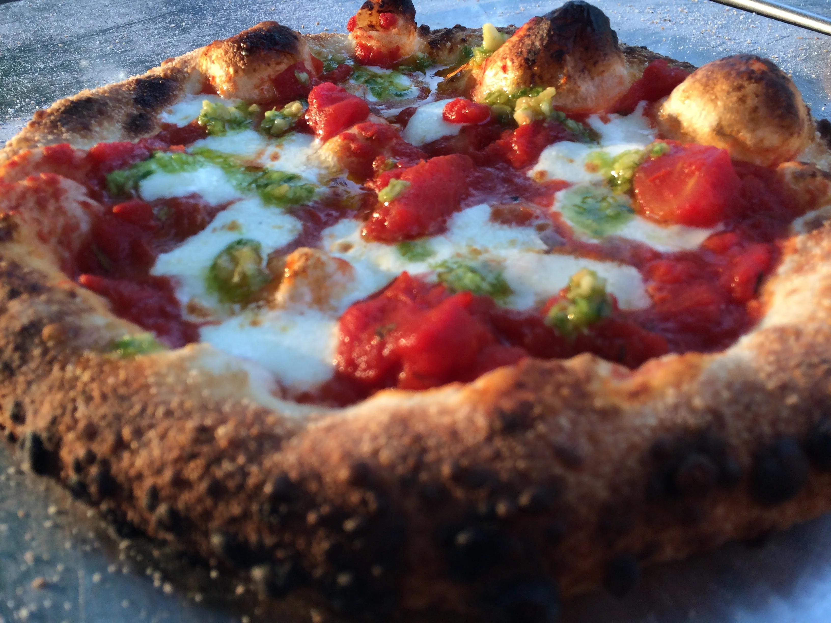 Delicious gourmet pizza with fresh toppings on a wooden table.
