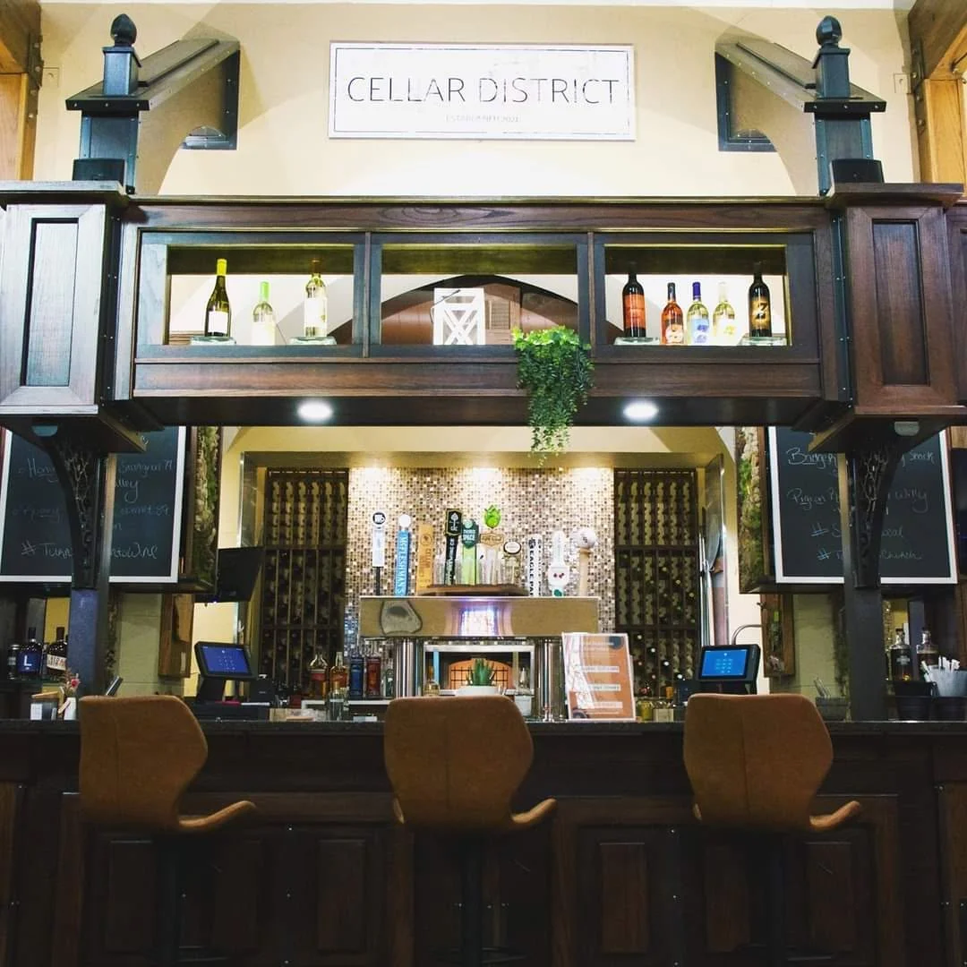 Stylish bar area with wooden accents and wine display