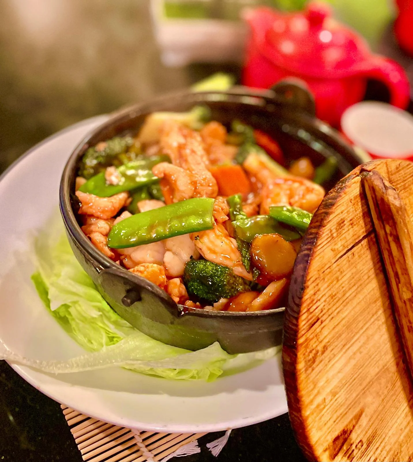 Chinese stir-fried chicken with vegetables in a clay pot