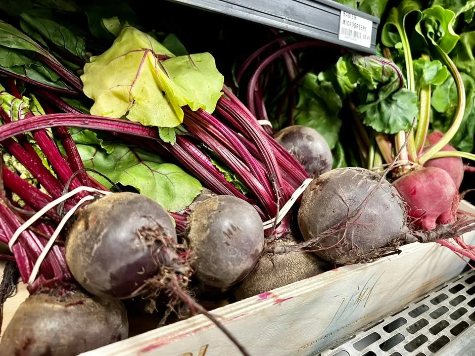 Fresh beets and greens in a market display