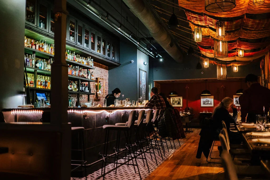 Cozy restaurant interior with a modern bar and warm lighting