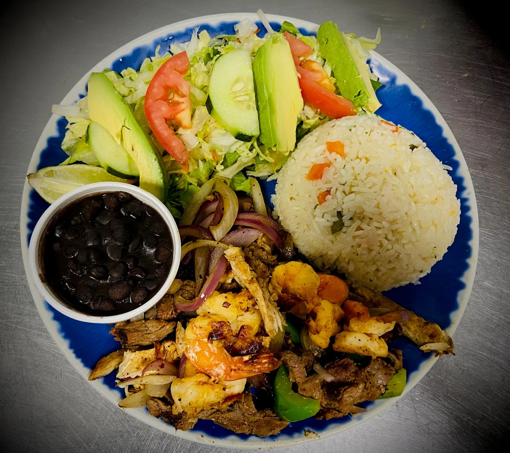 Grilled mixed seafood and meat platter with rice and salad