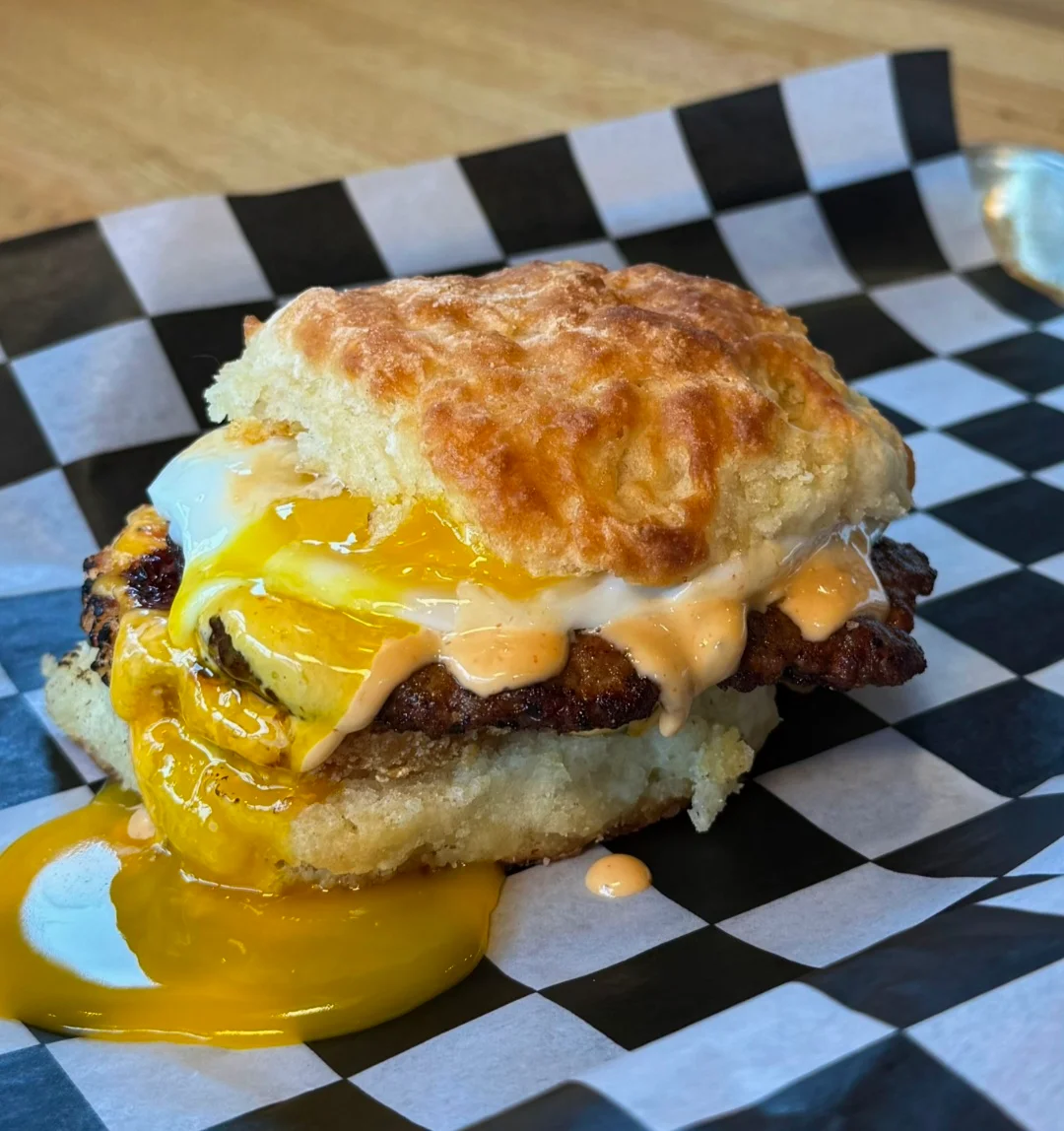 Delicious gourmet burger with toppings on a wooden table