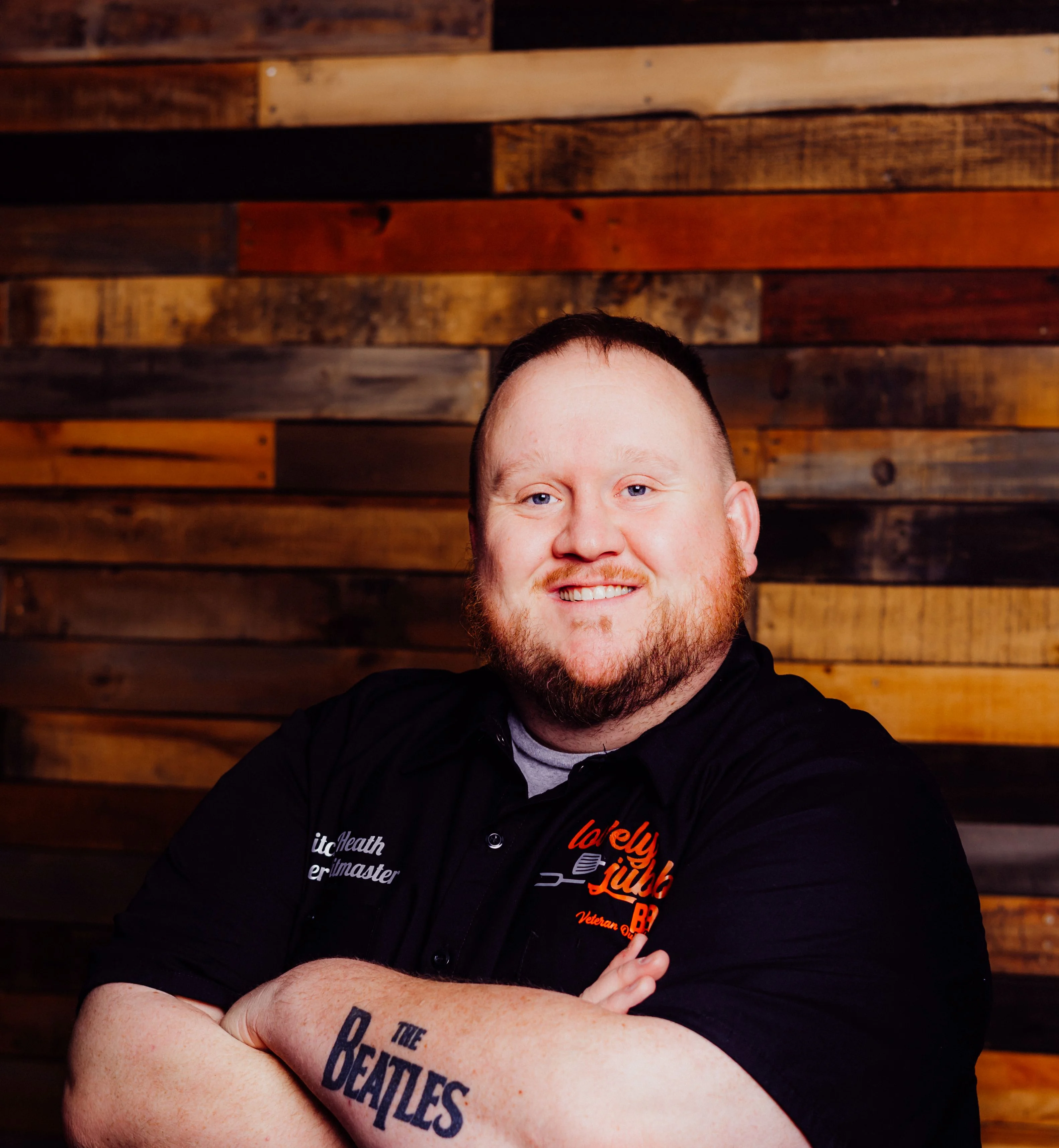 Chef posing confidently in a rustic restaurant setting