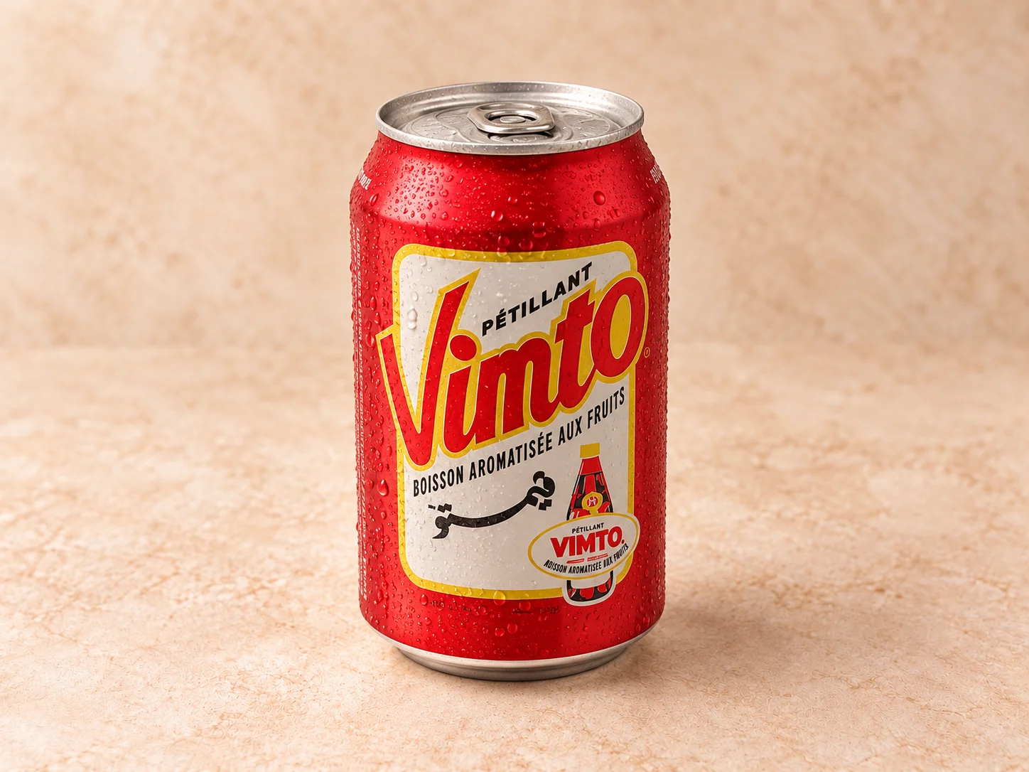 A red aluminum can of a fruit-flavored soft drink, displaying condensation on its surface.
