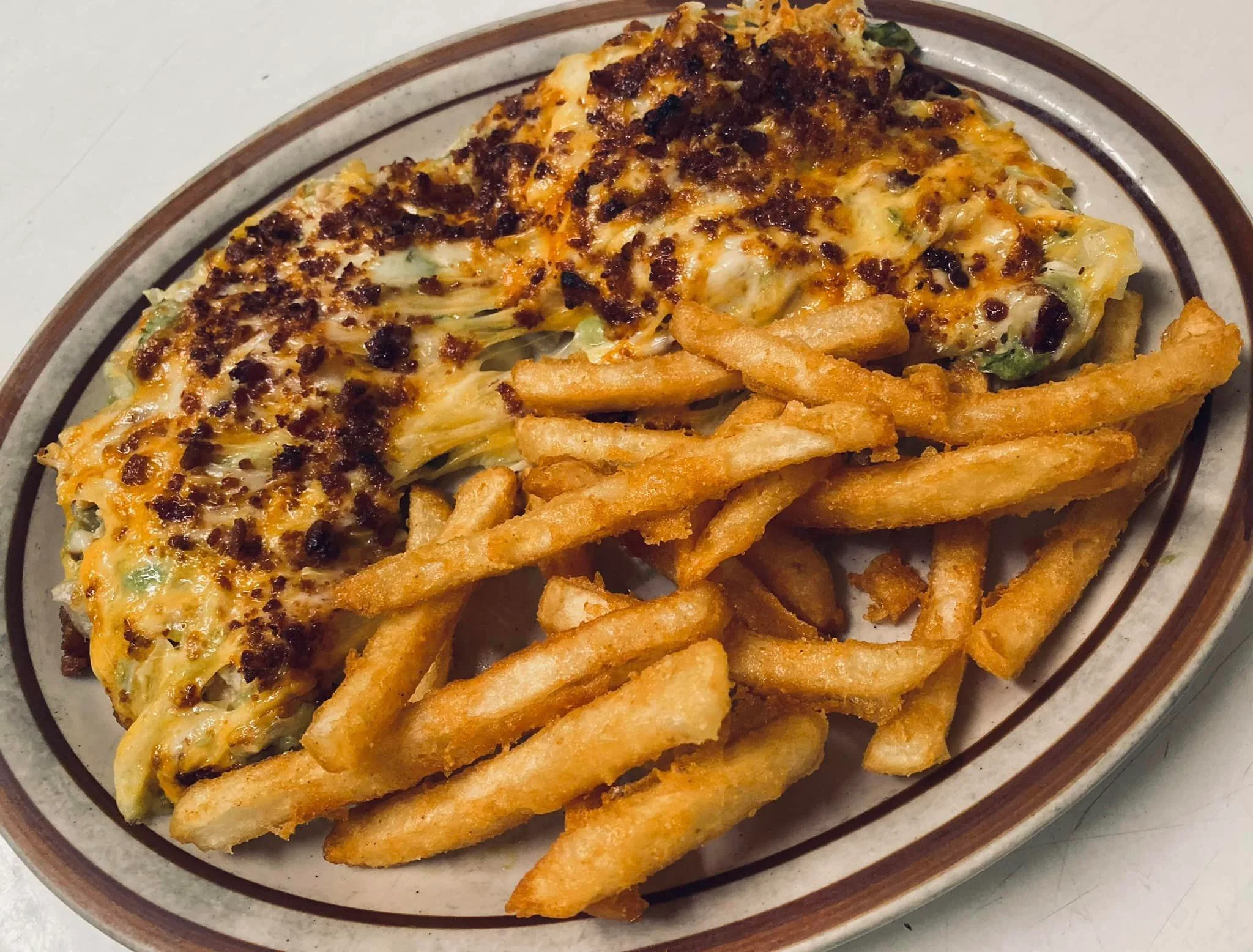Cheesy baked casserole with fries, a comfort food classic