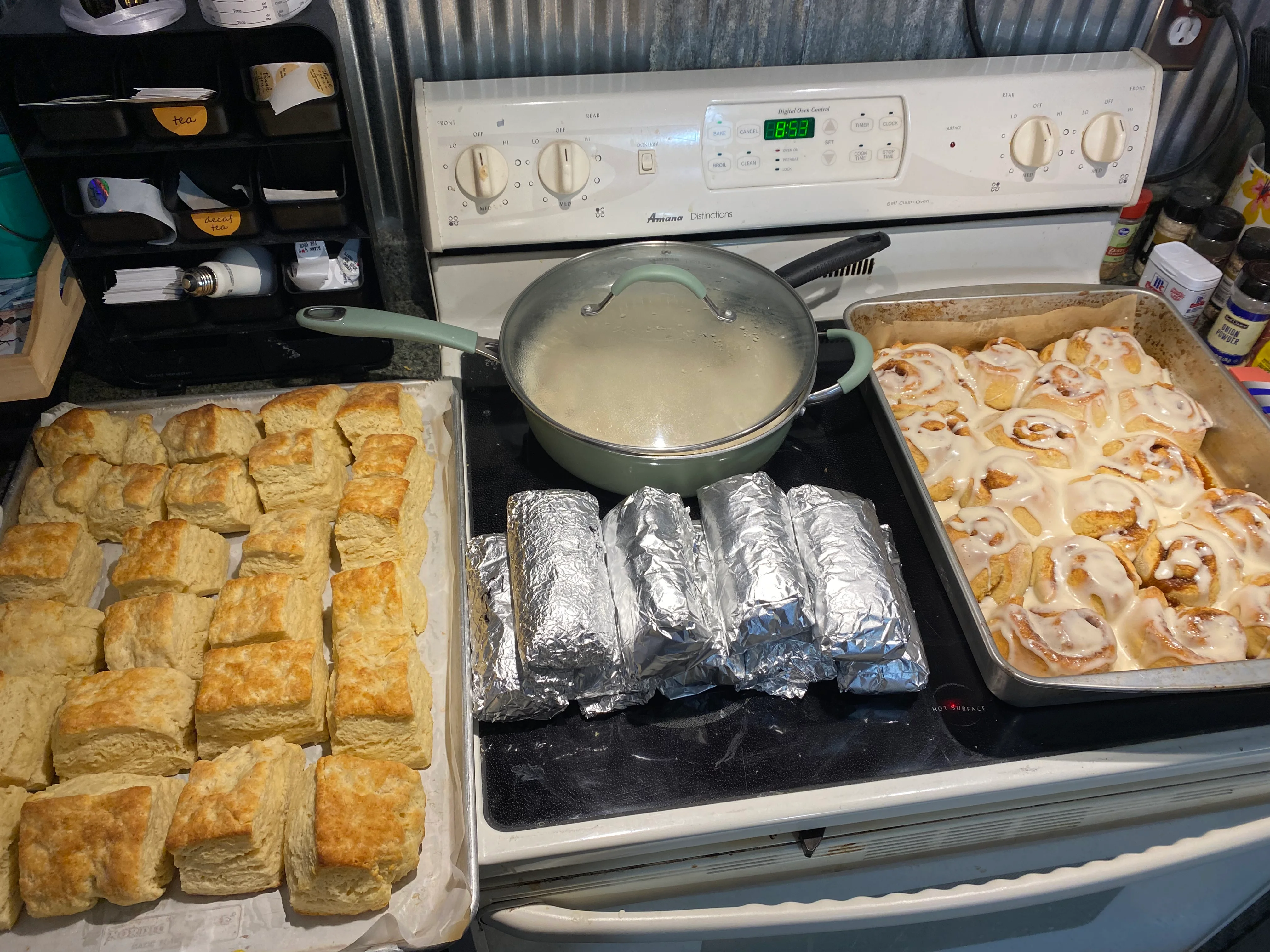 Freshly baked cinnamon rolls and biscuits on a kitchen counter