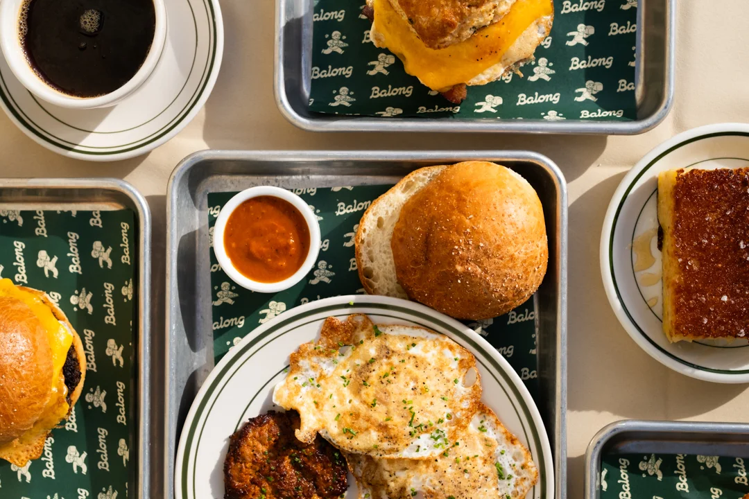 Classic American breakfast with eggs, biscuit, and coffee on a tray