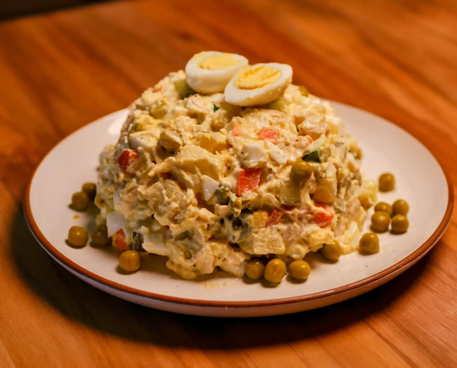 Russian Olivier salad garnished with boiled eggs