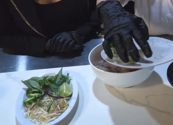 A cook preparing pho