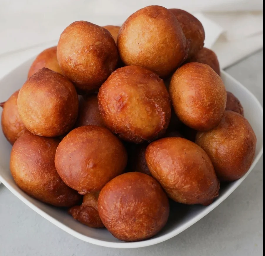 Golden Nigerian puff-puff served in a bowl