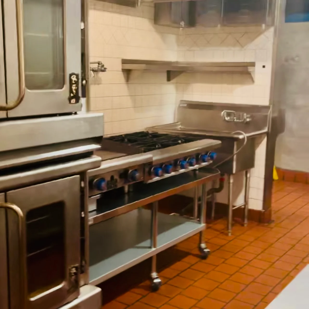 Commercial kitchen with stainless steel appliances and cooking equipment
