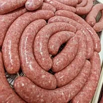 Freshly made Italian sausages coiled on a tray